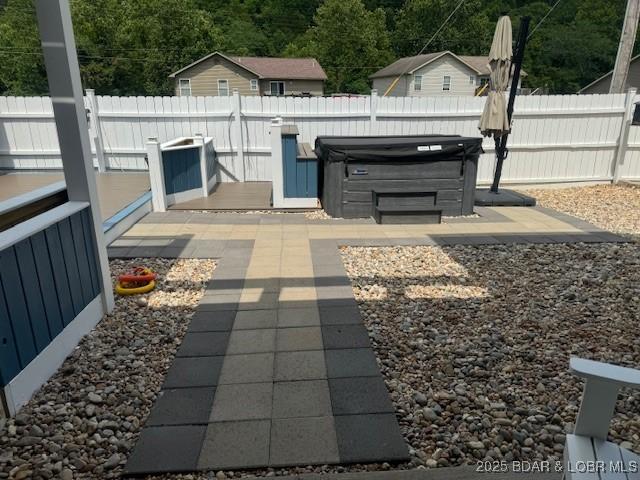 362 Merlin Dr, Camdenton, MO 65020 - view of patio / terrace featuring a hot tub and a view of trees