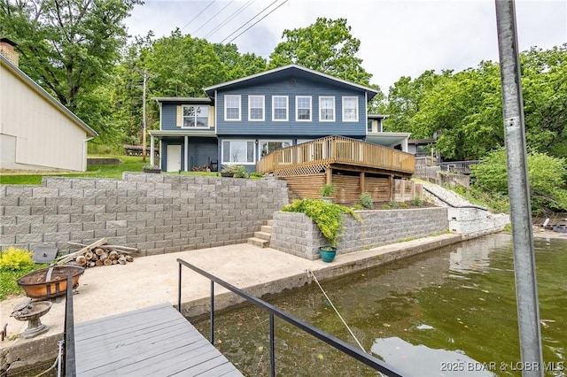 138 Siesta Cir, Camdenton, MO 65020 - rear view of property with an outdoor fire pit, a patio area, view of scattered trees, and a deck with water view