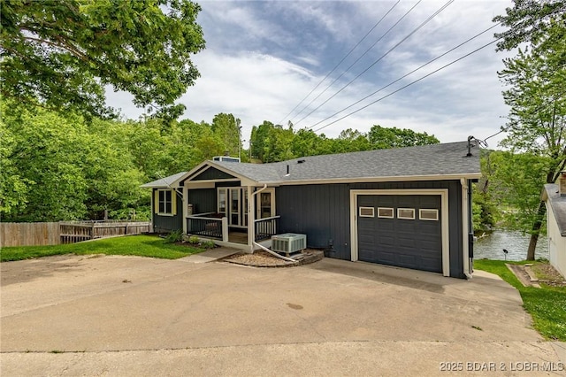 138 Siesta Cir, Camdenton, MO 65020 - single story home featuring a garage, driveway, central AC unit, and roof with shingles