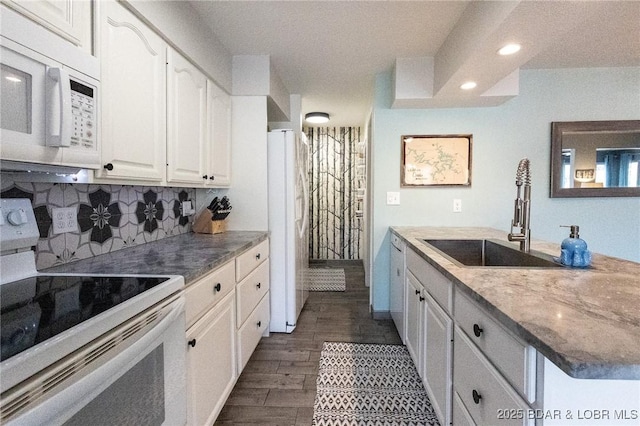 138 Siesta Cir, Camdenton, MO 65020 - kitchen with white appliances, a sink, white cabinetry, backsplash, and recessed lighting