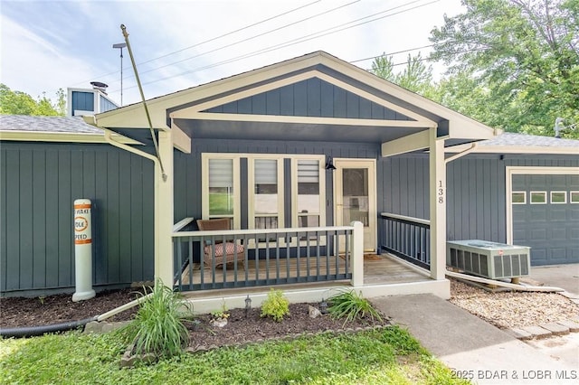 138 Siesta Cir, Camdenton, MO 65020 - view of front of home featuring a porch, an attached garage, and a shingled roof