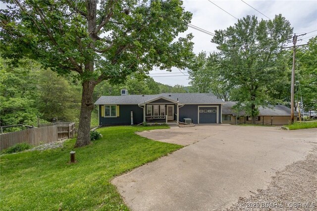 138 Siesta Cir, Camdenton, MO 65020 - view of front of home featuring driveway, an attached garage, and a sunroom