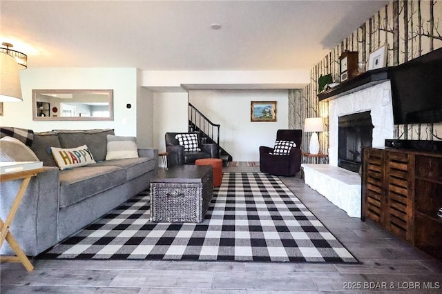 138 Siesta Cir, Camdenton, MO 65020 - living area featuring wood finished floors, a fireplace with raised hearth, and stairs