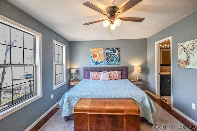 138 Siesta Cir, Camdenton, MO 65020 - bedroom featuring baseboards, multiple windows, and ensuite bath