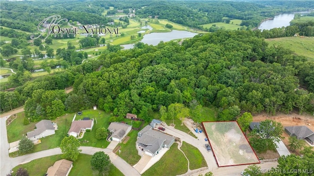 6 Sam Dr, Kaiser, MO 65047 - aerial view of residential area with a large body of water, property boundaries highlighted, and a forest