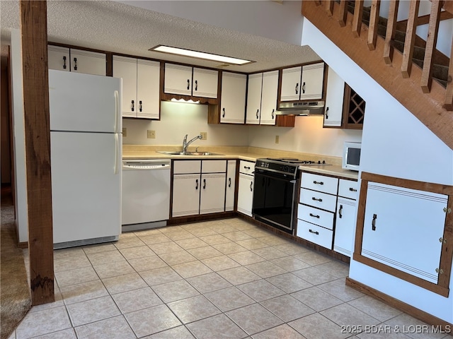 870 Jupiter Rd, Camdenton, MO 65020 - kitchen with white appliances, a sink, under cabinet range hood, light countertops, and a textured ceiling