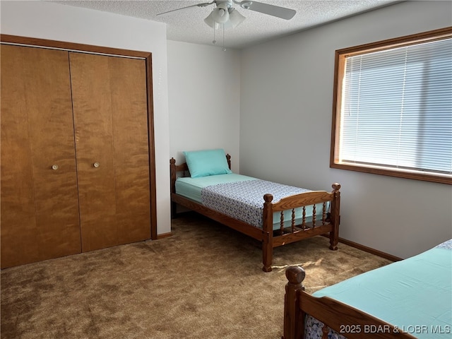 870 Jupiter Rd, Camdenton, MO 65020 - bedroom with carpet floors, a closet, a textured ceiling, and a ceiling fan