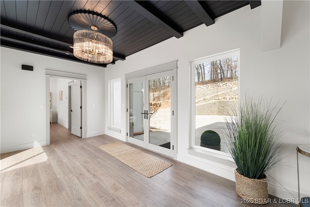 154 Via Cresta Dr, Sunrise Beach, MO 65079 - unfurnished room featuring wood ceiling with exposed beams, wood finished floors, baseboards, a chandelier, and french doors