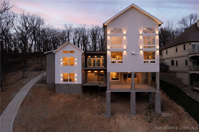 154 Via Cresta Dr, Sunrise Beach, MO 65079 - back of house at dusk with stucco siding