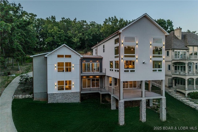 154 Via Cresta Dr, Sunrise Beach, MO 65079 - rear view of property with a lawn and stucco siding
