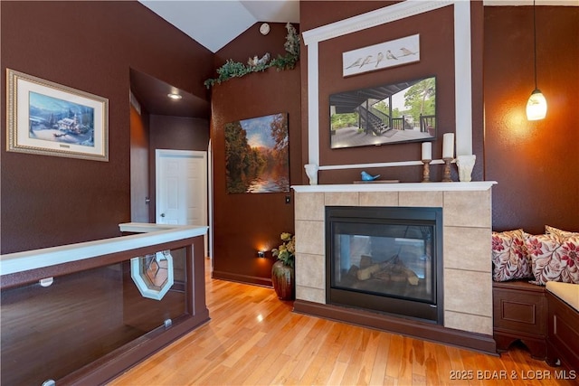179 Regency Cove Dr, Lake Ozark, MO 65049 - living room with light wood finished floors, lofted ceiling, and a fireplace