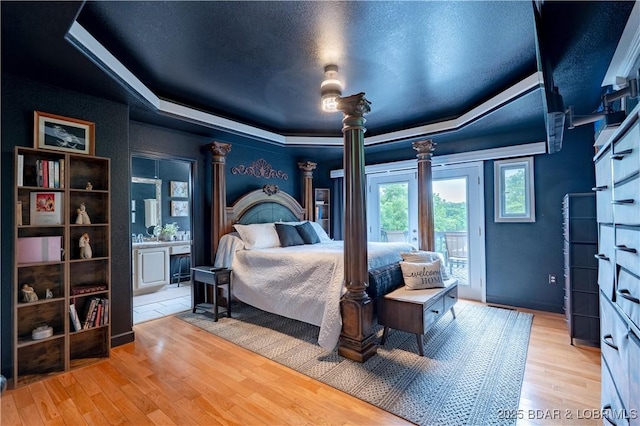 179 Regency Cove Dr, Lake Ozark, MO 65049 - bedroom featuring a raised ceiling, access to exterior, light wood-style flooring, and ensuite bathroom