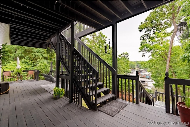 179 Regency Cove Dr, Lake Ozark, MO 65049 - wooden terrace featuring stairway and outdoor dining area