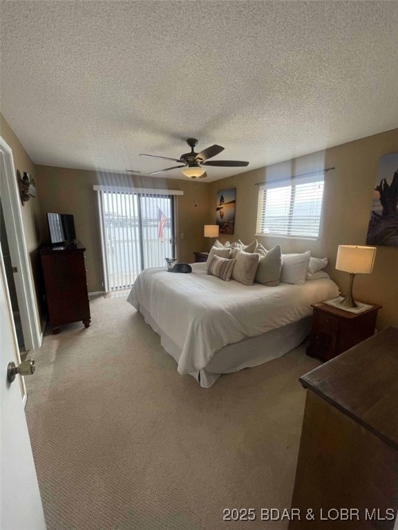 821 Winn Rd Unit 10D, Osage Beach, MO 65065 - bedroom featuring access to exterior, a textured ceiling, light carpet, and ceiling fan