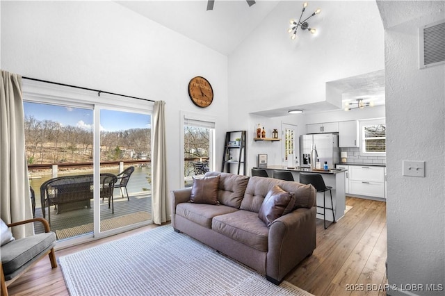 855 Ginger Rd, Lake Ozark, MO 65049 - living area with light wood-style flooring, high vaulted ceiling, plenty of natural light, and ceiling fan