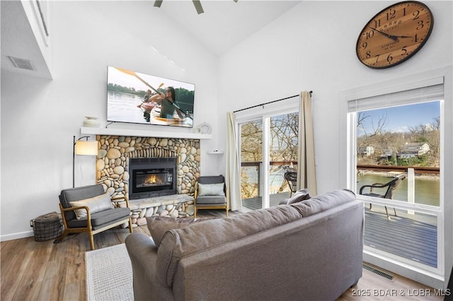 855 Ginger Rd, Lake Ozark, MO 65049 - living room featuring a fireplace, wood finished floors, high vaulted ceiling, baseboards, and ceiling fan