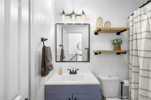 855 Ginger Rd, Lake Ozark, MO 65049 - bathroom featuring vanity, toilet, and a textured wall