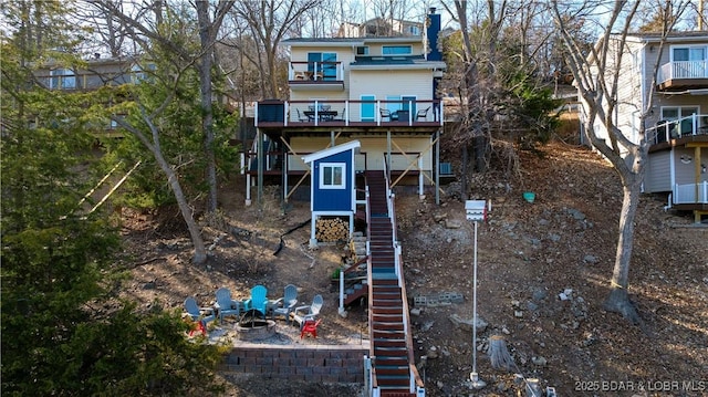 855 Ginger Rd, Lake Ozark, MO 65049 - rear view of property with stairs, a fire pit, and a wooden deck