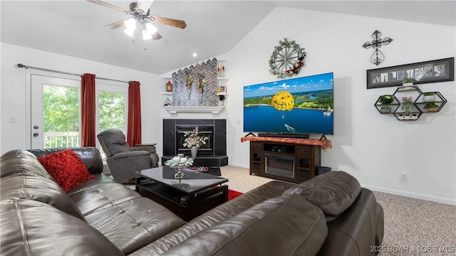 119 Camelot Dr, Camdenton, MO 65020 - living area featuring lofted ceiling, a glass covered fireplace, ceiling fan, carpet floors, and baseboards
