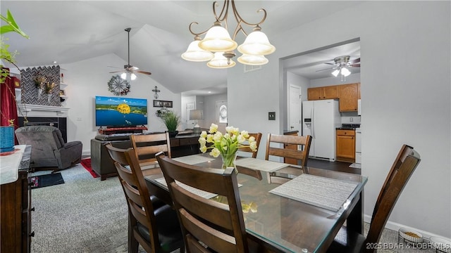 119 Camelot Dr, Camdenton, MO 65020 - dining room with ceiling fan, a fireplace, a chandelier, and lofted ceiling
