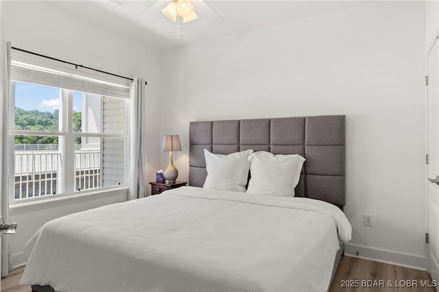 100 Trinity Pointe Dr Unit 4M, Camdenton, MO 65020 - bedroom featuring wood finished floors, baseboards, and a ceiling fan