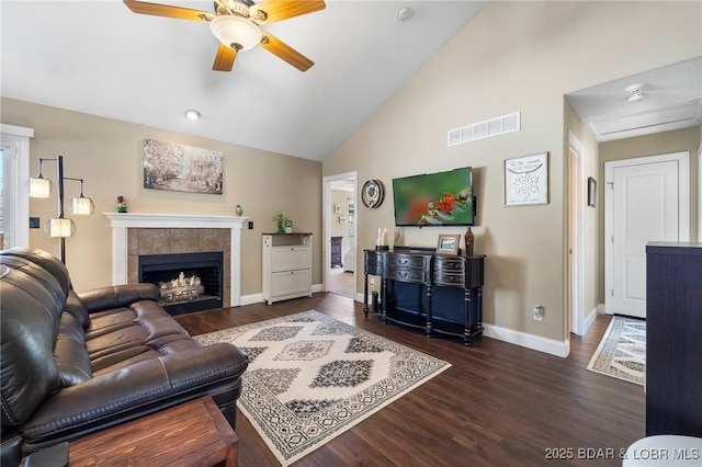 790 College Blvd, Osage Beach, MO 65065 - living area featuring a ceiling fan, dark wood finished floors, baseboards, a tiled fireplace, and high vaulted ceiling