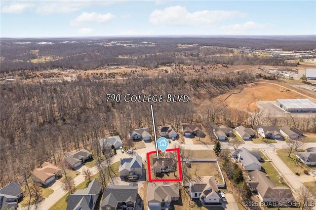 790 College Blvd, Osage Beach, MO 65065 - aerial overview of property's location featuring property boundaries highlighted, nearby suburban area, and a heavily wooded area