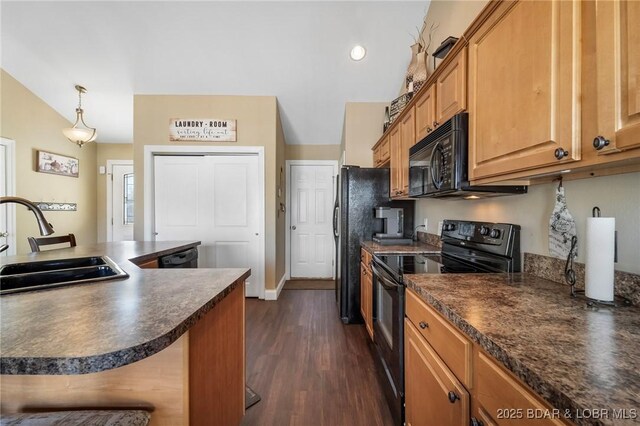 790 College Blvd, Osage Beach, MO 65065 - kitchen with black appliances, a sink, dark countertops, dark wood finished floors, and vaulted ceiling