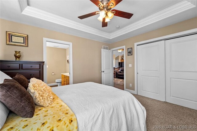 790 College Blvd, Osage Beach, MO 65065 - carpeted bedroom featuring a tray ceiling, crown molding, a closet, ensuite bath, and baseboards