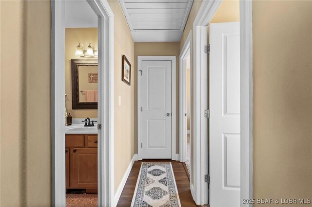 790 College Blvd, Osage Beach, MO 65065 - hall featuring dark wood-type flooring, a sink, and baseboards
