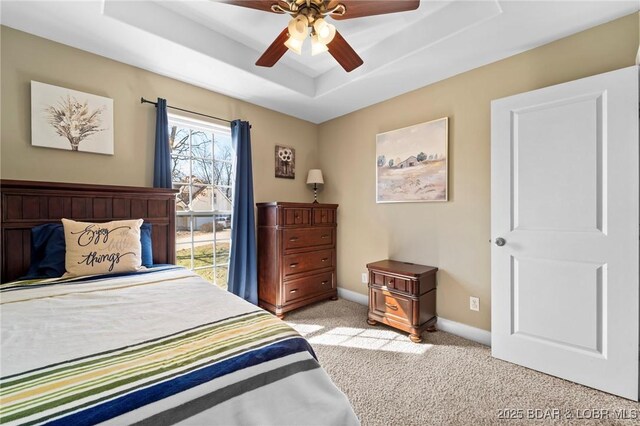 790 College Blvd, Osage Beach, MO 65065 - bedroom with light colored carpet, a tray ceiling, baseboards, and a ceiling fan