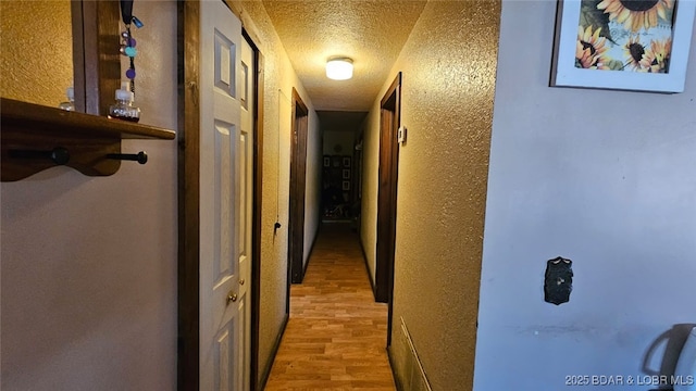 1501 Long Ln, Eldon, MO 65026 - hallway with a textured ceiling, wood finished floors, and a textured wall