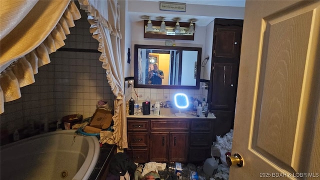 1501 Long Ln, Eldon, MO 65026 - full bathroom with a jetted tub, vanity, and backsplash