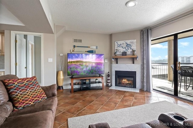 90 Falls Point Dr Unit 2C, Lake Ozark, MO 65049 - tiled living area with a textured ceiling and a warm lit fireplace