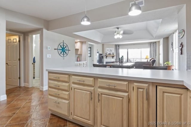 90 Falls Point Dr Unit 2C, Lake Ozark, MO 65049 - kitchen featuring light brown cabinets, light countertops, a ceiling fan, and open floor plan