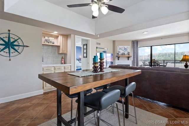 90 Falls Point Dr Unit 2C, Lake Ozark, MO 65049 - dining room featuring ceiling fan, baseboards, dark tile patterned floors, and recessed lighting