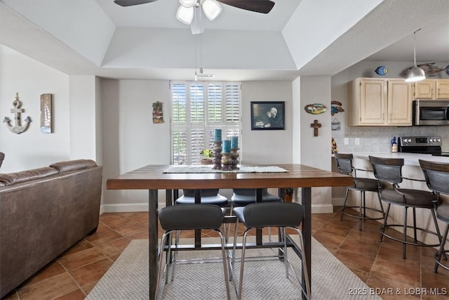 90 Falls Point Dr Unit 2C, Lake Ozark, MO 65049 - dining space with dark tile patterned flooring, a raised ceiling, a ceiling fan, and baseboards