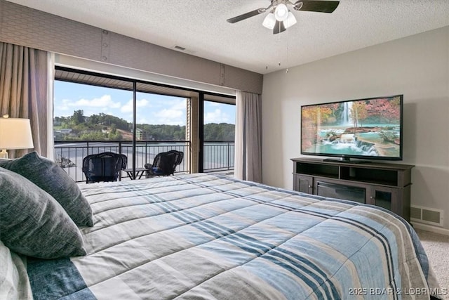90 Falls Point Dr Unit 2C, Lake Ozark, MO 65049 - bedroom featuring access to exterior, a textured ceiling, carpet, and a ceiling fan