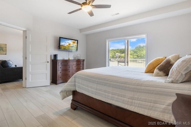 166 Oak Harbor Dr Unit 3D, Camdenton, MO 65020 - bedroom with light wood-style flooring, access to exterior, and ceiling fan