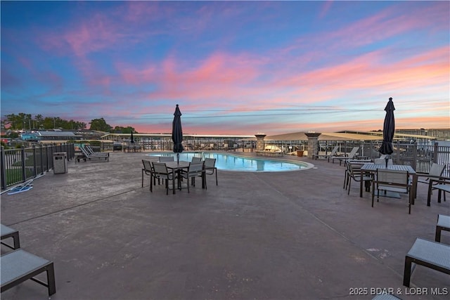 1184 Jeffries Rd Unit 310, Osage Beach, MO 65065 - pool at dusk featuring a community pool and a patio