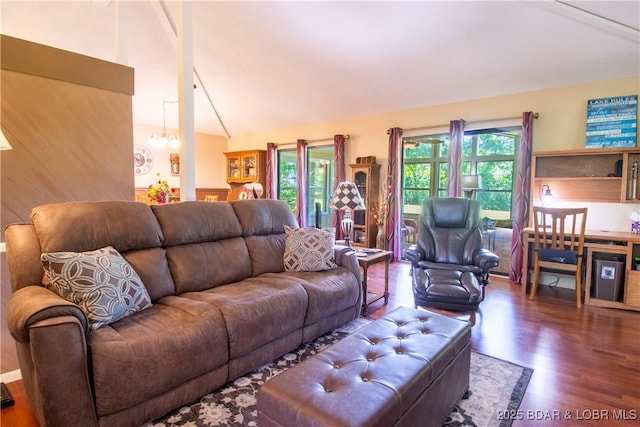 24 Canoe Ct, Osage Beach, MO 65065 - living area with wood finished floors, lofted ceiling, plenty of natural light, and a chandelier