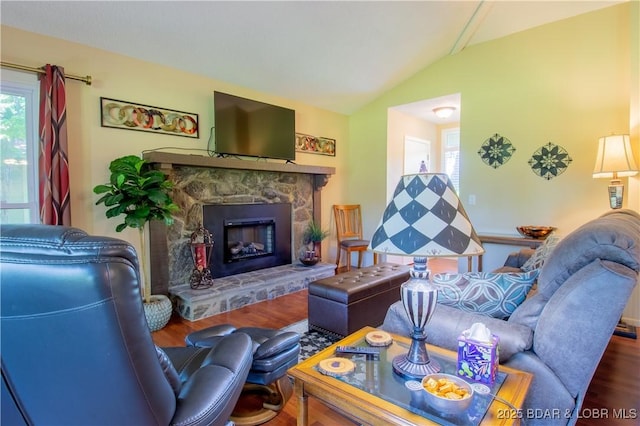 24 Canoe Ct, Osage Beach, MO 65065 - living room featuring lofted ceiling, plenty of natural light, a fireplace, and wood finished floors