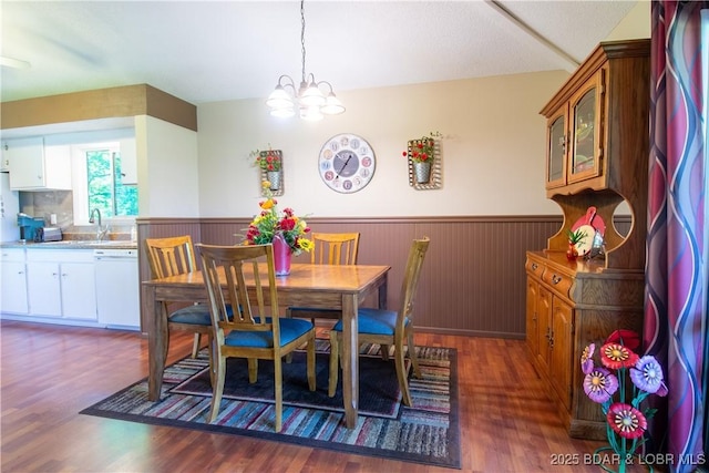 24 Canoe Ct, Osage Beach, MO 65065 - dining room with a wainscoted wall, dark wood-type flooring, and a chandelier
