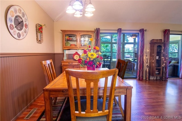 24 Canoe Ct, Osage Beach, MO 65065 - dining room featuring wood finished floors, healthy amount of natural light, lofted ceiling, a chandelier, and a wainscoted wall