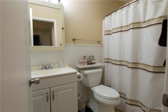 24 Canoe Ct, Osage Beach, MO 65065 - full bath featuring vanity, toilet, a wainscoted wall, and a shower with curtain