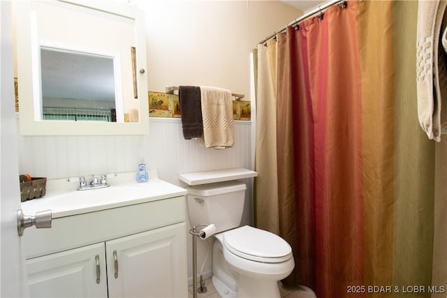 24 Canoe Ct, Osage Beach, MO 65065 - full bathroom with vanity, toilet, a wainscoted wall, and a shower with shower curtain