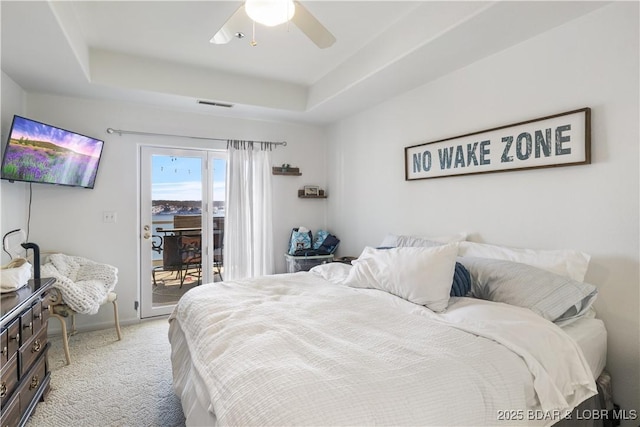 44 Emerald Bay Ct Unit 1B, Lake Ozark, MO 65049 - bedroom with access to outside, light colored carpet, a raised ceiling, and a ceiling fan