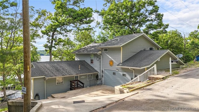 2195 Valley Rd, Osage Beach, MO 65065 - back of property with concrete driveway and a shingled roof