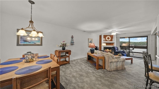 5940 Baydy Peak Rd Unit 325, Osage Beach, MO 65065 - carpeted living room featuring ceiling fan, a chandelier, and a fireplace