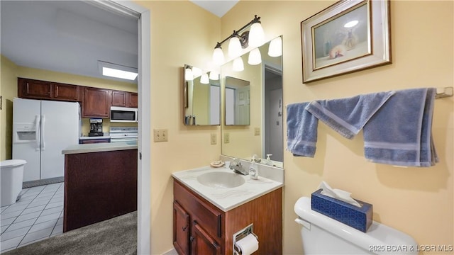 5940 Baydy Peak Rd Unit 325, Osage Beach, MO 65065 - half bath with toilet, vanity, and tile patterned floors
